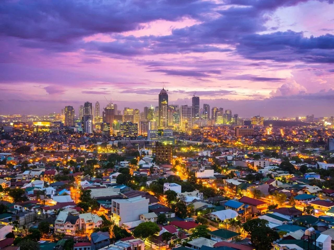 Manila skyline at dusk with city lights